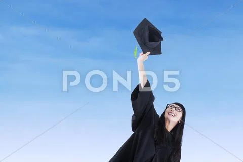 Asian bachelor throwing a graduation cap Stock Photos