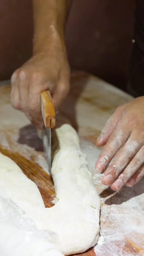 Asian Baker Cutting and Shaping Fresh Bread Dough with Bench Scraper Stock Footage 340863534