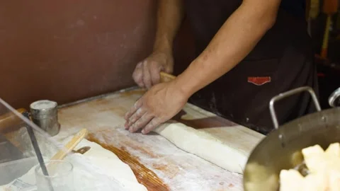 Asian Baker Using Bench Scraper to Prepare Dough for Bread Stock Footage 340966772