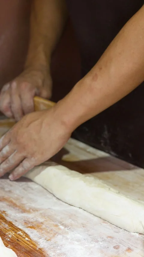 Asian Baker Using Bench Scraper to Prepare Dough on Wooden Table Stock Footage 341301598