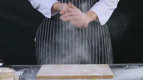 Asian bakery chefs clapping his hands filled with white flour. 動画素材 147088616