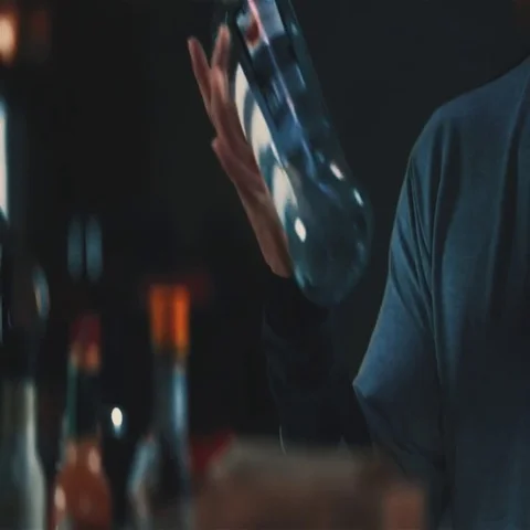 Asian bartender barman doing tricks bottle spin bar counter HD slow motion video Stock Footage 69377947