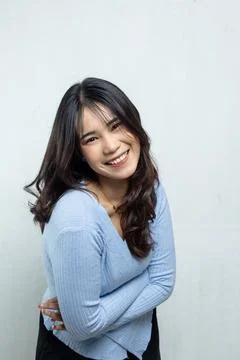 Asian beauty face posing for camera and hugging her own body Stock Photos