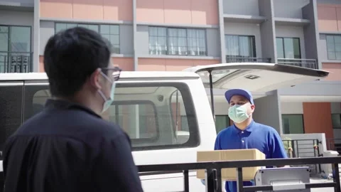 Delivery Man Wearing Protective Mask And Rubber Gloves Stock Photo