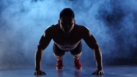Asian bodybuilder man push ups. Black smoke background. Silhouette Stock Footage 75177343