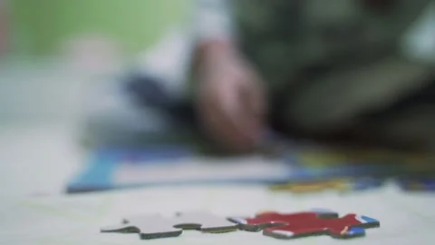Asian boy about 4 year old building paper jigsaws Stock Footage 171782833