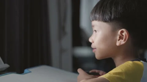 Asian boy about 5 years old using a wireless controller. Stock Footage 164524497