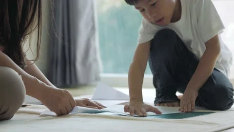Asian boy about 5 years olds in folding a paper airplane3 Stock Footage 165583346
