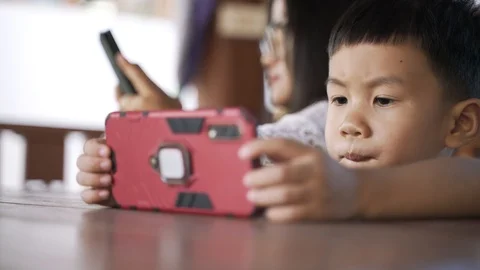 Asian boy addiction and keep using mobile phone Stock Footage 127365193