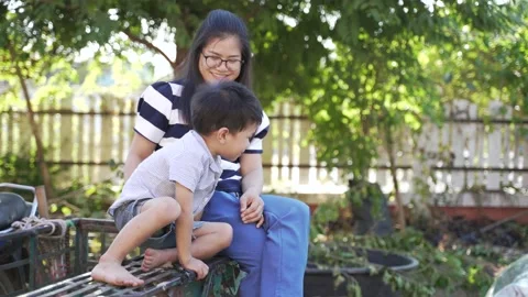 Asian boy in bad mood being persuade and encouraged by his mother Video stock 146834472