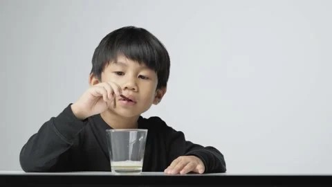 Asian boy blowing soap bubble with a plastic straw. Video stock 170225228