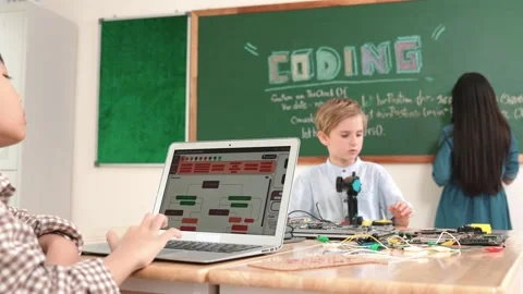 Asian boy coding program while friend fixing electric board at class. Pedagogy. Stock Footage 279104843