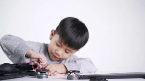 Asian boy connecting speaker wires Video stock 147337301