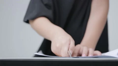 Asian boy cutting paper by stainless office cutter. Stock Footage 187637962