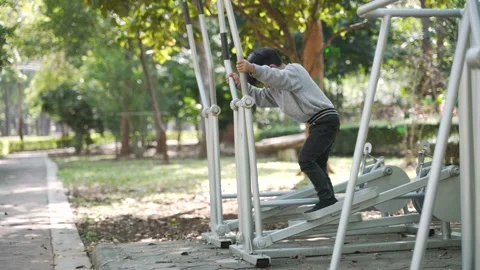 Asian boy doing exercise by using body rider trainer Stock Footage 148649195