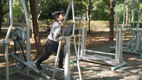 Asian boy doing exercise by using body rider trainer Stock Footage 158289466