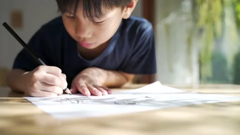 Asian boy doing his homework, drawing and painting picture Video stock 151255237