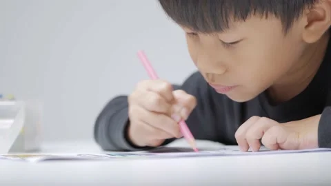 Asian boy doing his homework, drawing and painting picture. Stock Footage 170225286