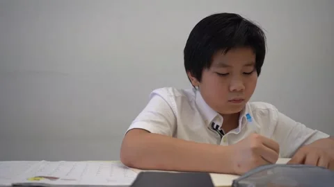 Asian Boy doing homework and study so hard 4K Stock Footage 139567286