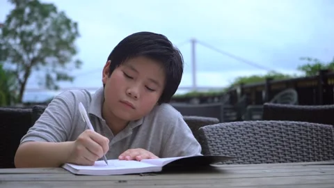 Asian Boy doing homework and study so hard 4K Stock Footage 139567966