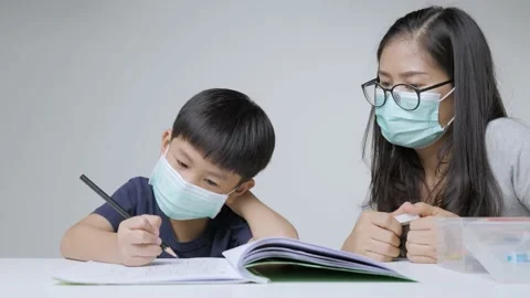 Asian boy doing homework with mother. Stock Footage 163287162