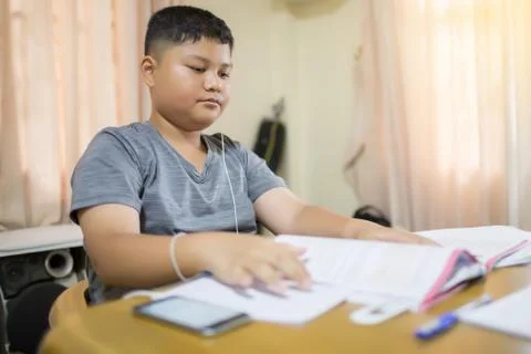 Asian boy is doing homework Stock Photos