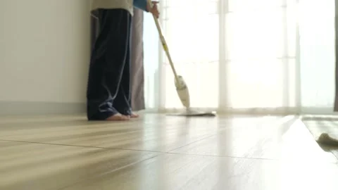 Asian boy doing house chore by cleaning the floor. Stock Footage 179516485