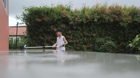 Asian boy doing house chores by cleaning and wiping the tiles floor. Stock Footage 229066487