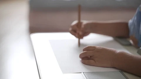 Asian boy drawing by using pencil as study at home Video stock 128789643