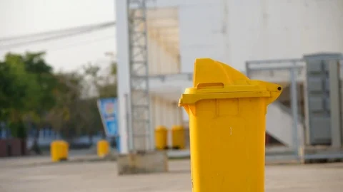 Asian boy drop empty bottle in yellow bin Stock Footage 73374250