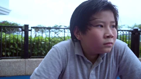 Asian boy feels afraid alone outdoor, panic disorder, depression 4K Stock Footage 139568086