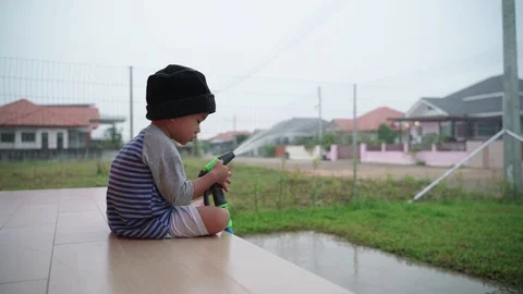 Asian boy help watering grass yard Stock-Footage 97094110