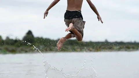 Asian boy jumping in the river Stock Footage 79516786