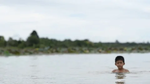 Asian boy jumping in the river Stock Footage 79516833