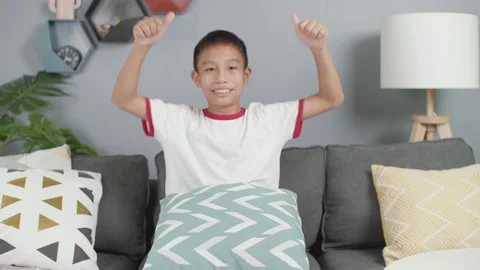 Asian boy laughs looking at camera in living room at home. Stock Footage 156241675