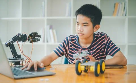 Asian boy learning and studying the work of technology robots.homeschool an.. Stock Photos