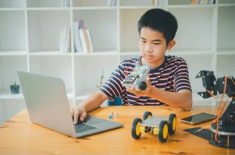 Asian boy learning and studying the work of technology robots.homeschool an.. Stock Photos
