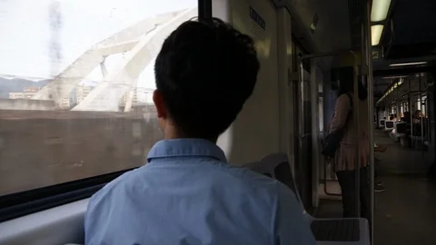 Asian boy looking outside the train window Video stock 88440558