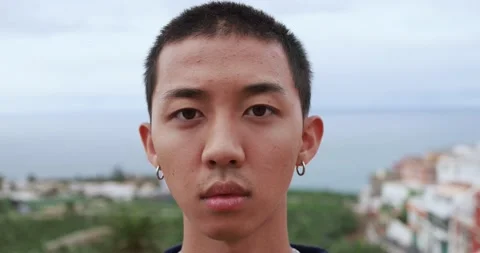 Asian boy looking serious on camera outdoor Stock Footage 164378922