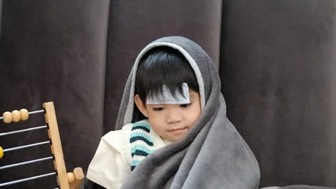 Asian boy Lying sick, he had a fever reducing patch on his forehead Stock Footage 252385893