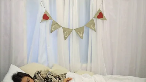 Asian boy makes a surprise for his girlfriend on Valentine's Day while she Stock Footage