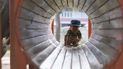 Asian boy playing and having fun with wooden tunnel Stock Footage 86506354