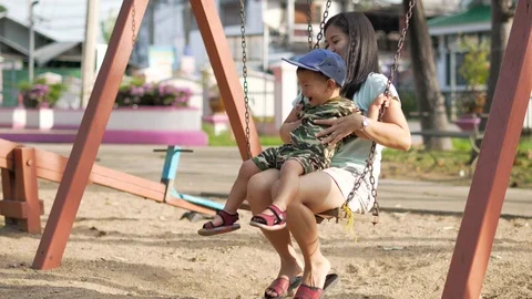 Asian boy playing and having fun with seesaw at kid training playground Video stock 86506550