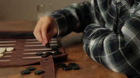 Asian boy playing backgammon in dining room. Profile. Stock Footage 224241101