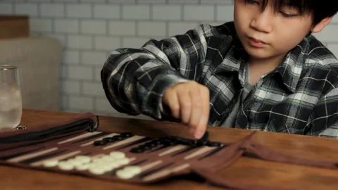 Asian boy playing backgammon at home. Stock Footage 224234202