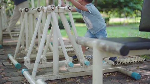 Asian boy playing at kid training playground with his mother Stock Footage 90411570
