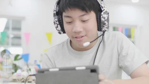 Asian boy Playing online games with friends by tablet computer. Video stock 124206252