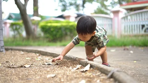 Asian boy playing with sand at training playground Stock Footage 88632385