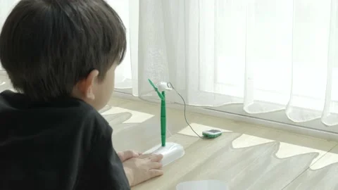 Asian boy playing solar cell toy. Stock Footage 160277884
