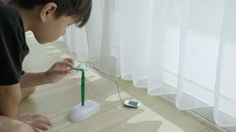 Asian boy playing solar cell toy. Stock Footage 165681271